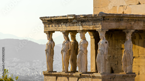 Sunset over female statues in The caryatid porch of the Erechtheion on Acropolis, Athens, Greece