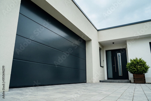 Modern residential house exterior with dark grey garage door