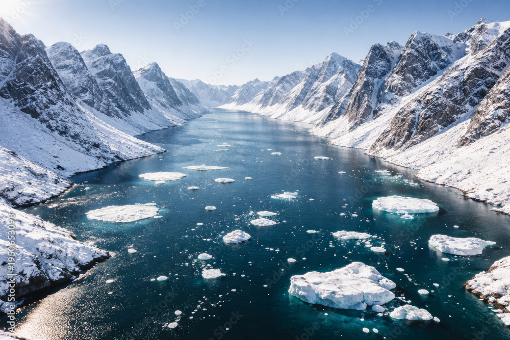 Obraz premium Majestic snowy mountains surrounding a calm blue glacial river