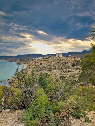 Torreon Malladeta coastal landscape in Villajoyosa Spain with dramatic storm clouds and Mediterranean shoreline