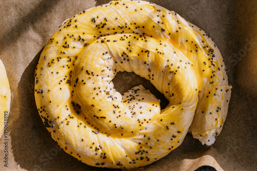 Spiral oven-ready Moldovan placinta with egg wash on parchment paper