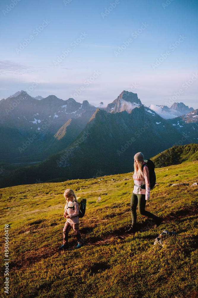 Obraz premium Family summer vacations in Norway mother hiking with child outdoors travel active healthy lifestyle - parent and kid explore mountain trails in Lofoten Islands adventure trip together eco tourism