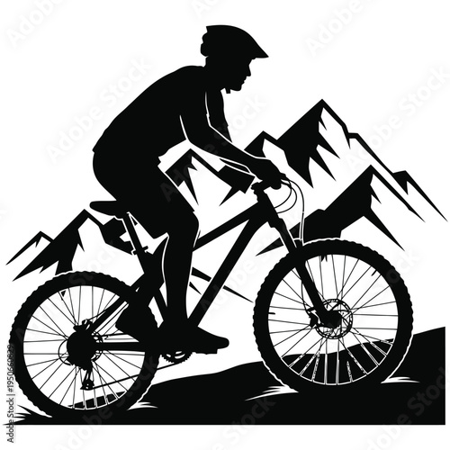 Mountain biker ascending rugged terrain against a mountain backdrop