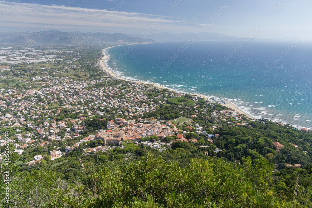 Fototapeta premium Aerial View of Coastal Town with Forest and Long Beach