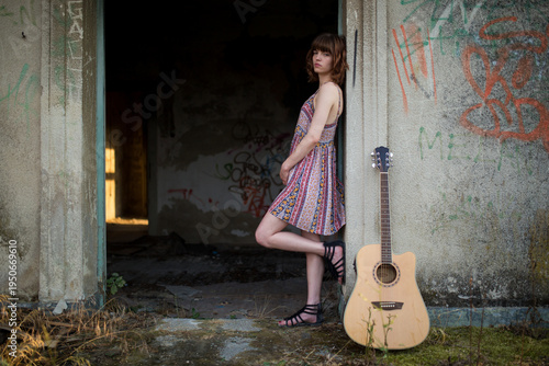 Female Musician with Guitar in Urban Setting