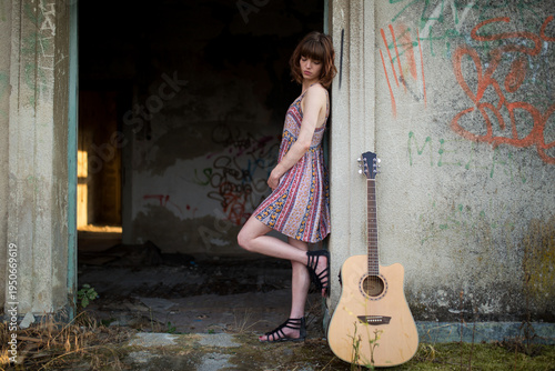 Female Musician with Guitar in Urban Setting