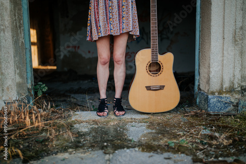 Woman Standing in Doorway with Acoustic Guitar