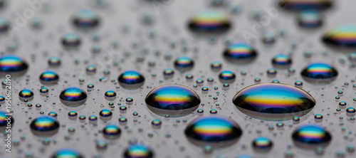 Close-up of iridescent water droplets on a reflective surface water drops condensation
