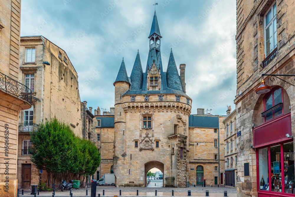 Obraz premium Porte Cailhau historic medieval gate and surrounding classical architecture on Place du Palais in Bordeaux city center, Gironde, Nouvelle-Aquitaine, France. French old town square