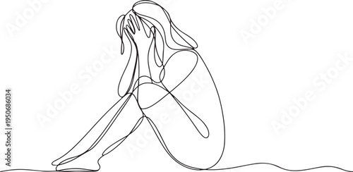 Woman sitting with knees pulled to chest and face hidden