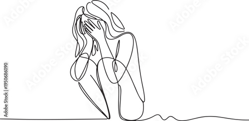 Woman crouching with face covered by hands in distress