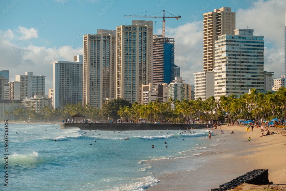 Obraz premium Bustling Waikiki Coast Scene. Lively Oceanfront Environment Filled With Surfers And Tourists