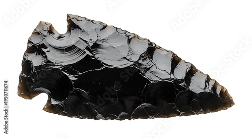 Ancient obsidian arrowhead meticulously crafted by prehistoric humans showcases sharp edges and intricate flaking patterns representing primitive tools and historical artifacts
