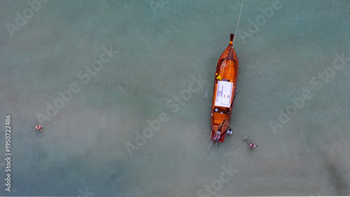 Top down aerial old wooden boats on dock Phuket southern Thailand