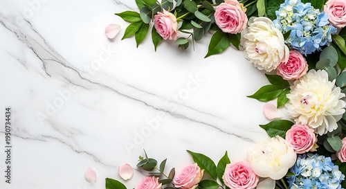 Floral arrangement of roses, peonies and hydrangeas on marble backdrop