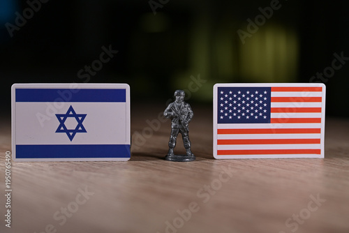 A tin soldier on the background of the flags of the United States and Israel.