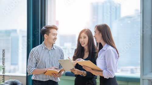 A group of Gen Z Asian business consulting, exchanging information in offices, co-working spaces.