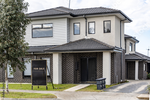 Принти на полотні Modern suburban townhouse for sale in Melbourne, Australia with real estate signboard in front yard