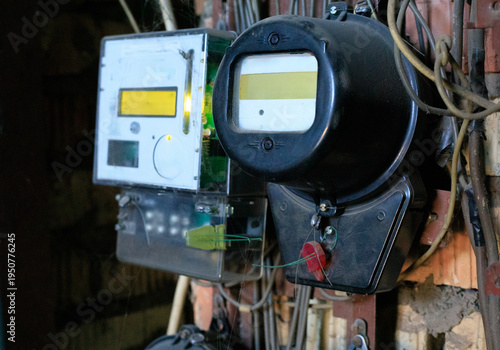 Photos Old analog electricity meter stands alongside a modern digital replacement in a