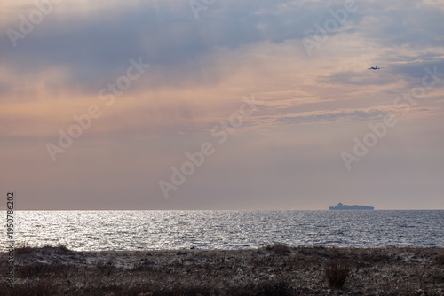 Cargo Ship and Aircraft on Horizon at Sandy Hook Beach New Jersey
