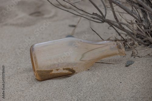 Weathered Glass Bottle Half Buried in Sand at Sandy Hook Beach New Jersey
