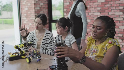 eacher teaches students how to build and design robots in the classroom	