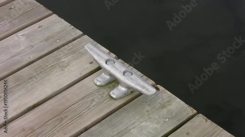 Cleat on wooden deck with water. Top down, diagonal view. HDV footage. HD.
