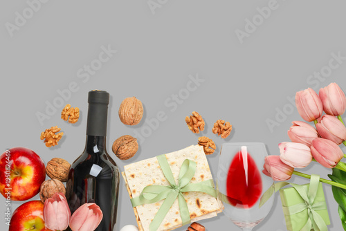 Фотография Table set with wine, matzah, apples, nuts, and flowers