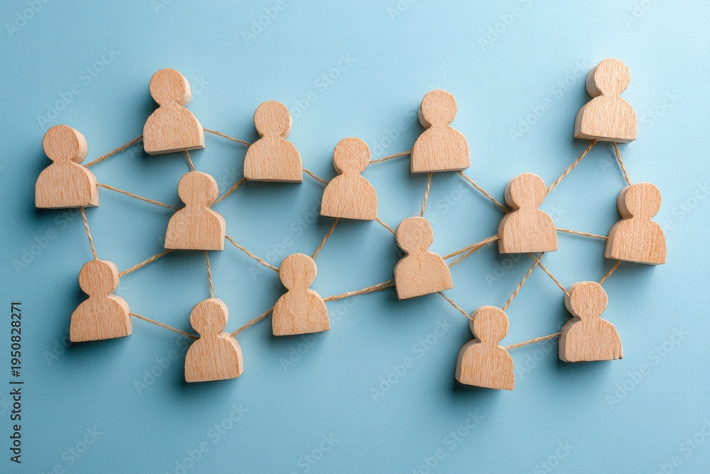 Obraz premium Interconnected Connections: A creative visual representation of social and professional connections, formed by a network of wooden figures interlinked with delicate threads.