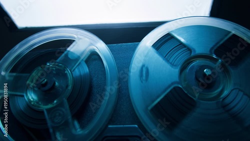 Tape audio music player, VHS studio magnetic tape, vintage retro spool reel to reel player and recorder, magnetic tape data storage close up, music studio. 
