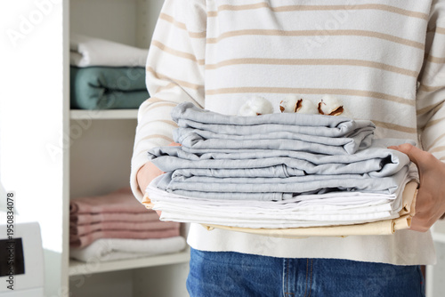 Woman with stack of bed she...