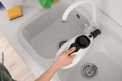 Female hand steam cleaning ...