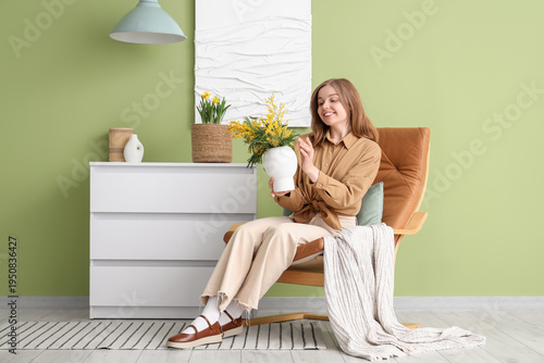 Young woman with mimosa flo...