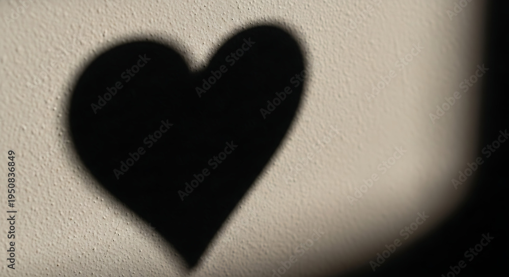 Obraz premium Soft shadow heart shape on textured wall minimalist love concept