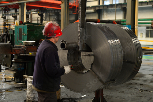 Workers on the production line of the strip steel coil factory are working