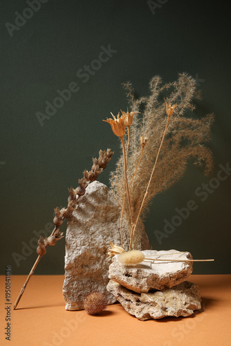 Dried flowers and stones on...