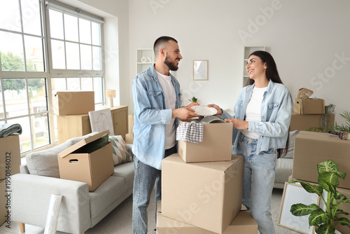 Happy young couple unpackin...