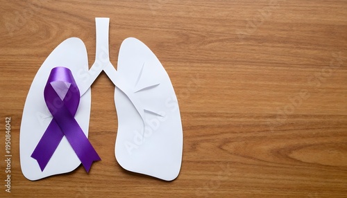 Lungs with a purple ribbon on a wooden backdrop, illustrating support and awareness for cystic fibrosis and its healthcare journey