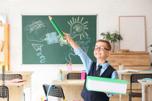 Cute little schoolboy with ...