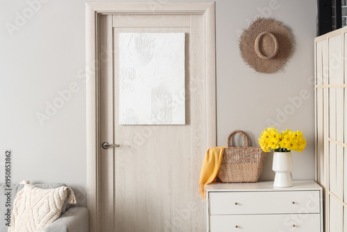 Stylish interior of hall with chest of drawers and door