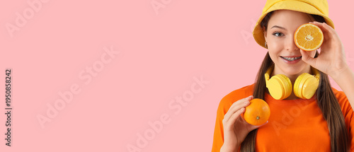 Young woman with oranges on...