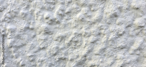 Close-up of white painted stucco roughcast wall with textured surface