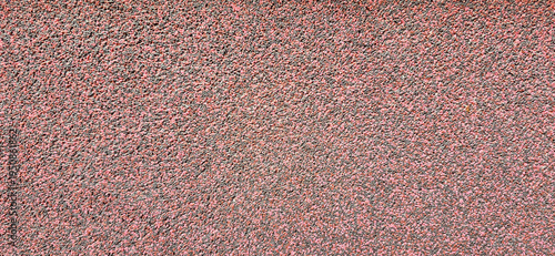 Red textured surface of small aggregate and gravel asphalt material