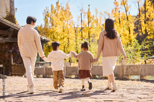 Young family visiting man-made historic town scenic site
