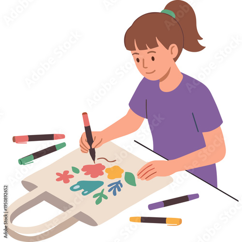 A woman is coloring on a tote bag with markers at home.