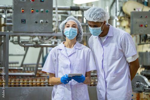 Quality control meeting in food processing plant industrial setting team collaboration professional environment