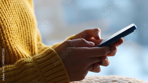 Hands texting on phone outdoors.