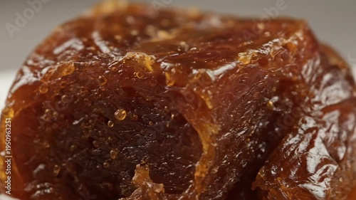 Extreme Close-up of Rich Caramelized Glaze on Sticky Brown Preserved Food, Showcasing Glossy Texture and Detail