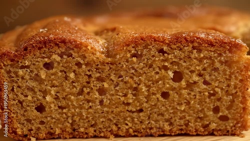 Macro close-up of freshly baked golden sponge cake or pound cake with a sugar glaze, showing the appetizing texture of the moist crumb and crust.