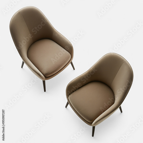 Two beige designer lounge chairs with sleek metal legs on a white background
